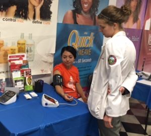 Volunteer Diana Flores gets her blood pressure checked by Rocky Vista University student volunteer Claire Simon. Colorado Black Health Collaborative volunteers are always the first patients, modeling good health monitoring. CBHC has given more than 5,000 checks since the program began in barbershops and salons.