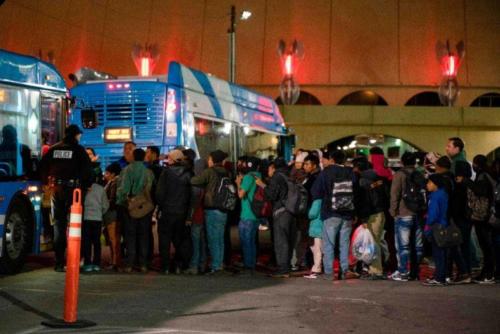 Asylum seekers board a bus after they were dropped off by ICE officials at the Greyhound bus station in El Paso to seek shelter.
