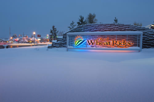 25. Welcome to Wheat Ridge sign in the snow